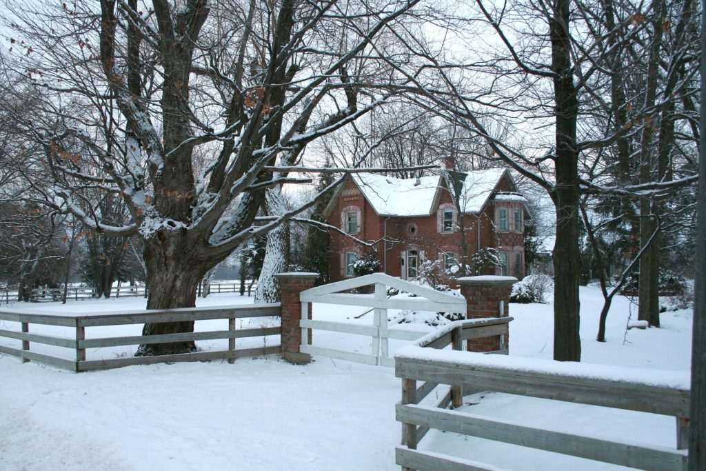 fenced snowy home