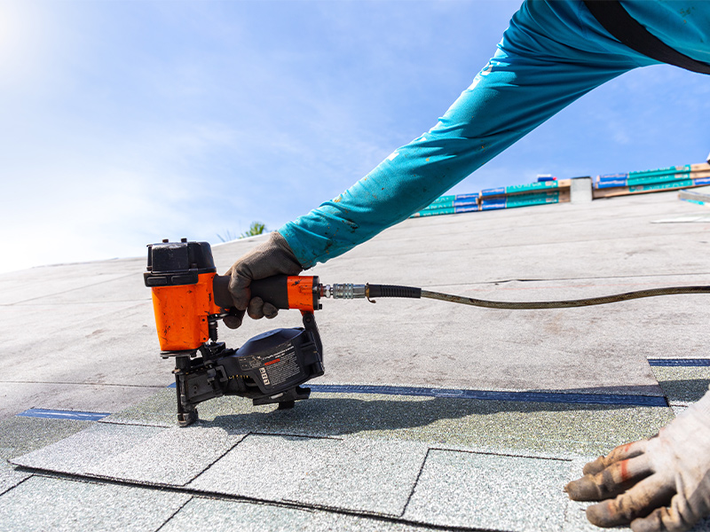 workers installing asphalt shingles