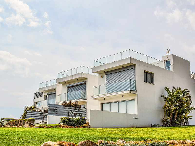 white residence with recent roof replacement services