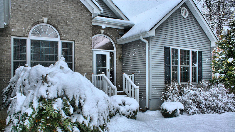 snowy Minnesota home with roof replacement services