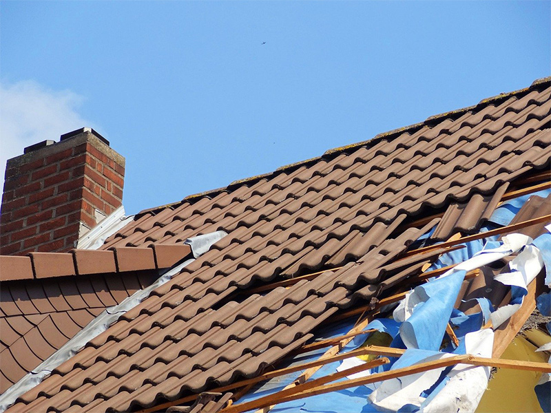 a tile roof with extensive storm damage repair
